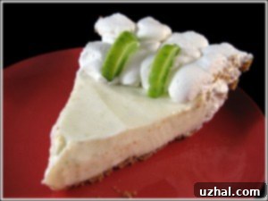 A slice of creamy Key lime pie with whipped cream on top, ready to be enjoyed.
