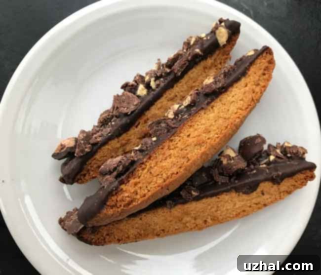 Golden brown biscotti logs freshly baked, showing their even shape.