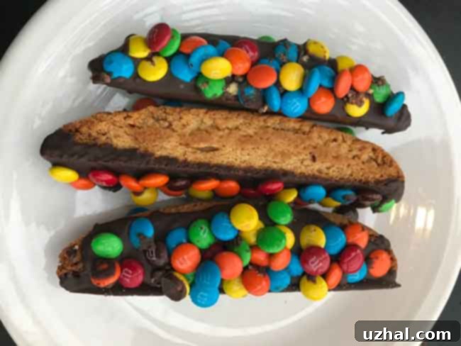 Finished Malted Milk Biscotti, half-dipped in chocolate and topped with chopped malt balls, arranged artfully.