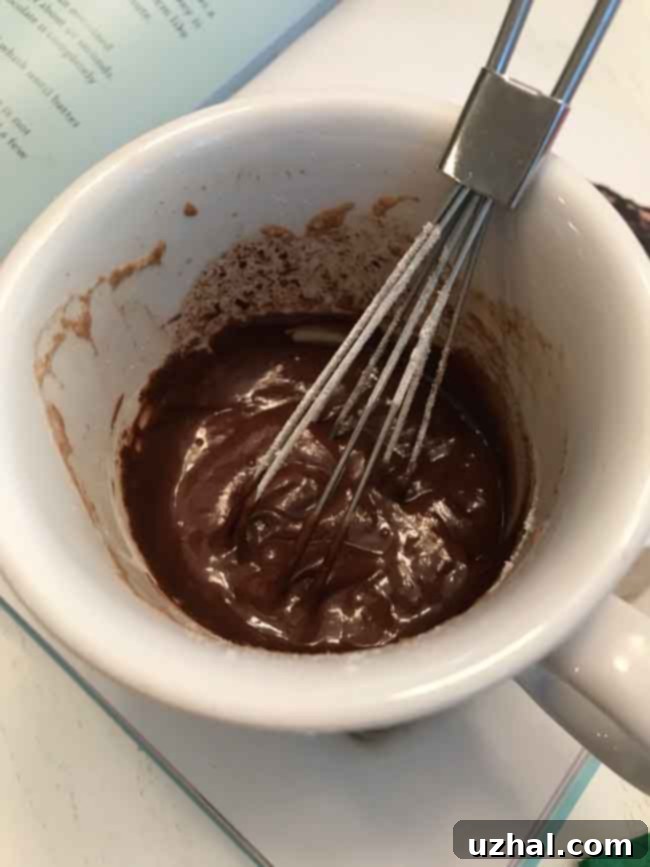 Hot chocolate mug cake recipe in action, showing the cake rising