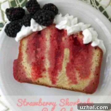 Strawberry Shortcake Poke Cake garnished with fresh berries and whipped cream, ready to be sliced.