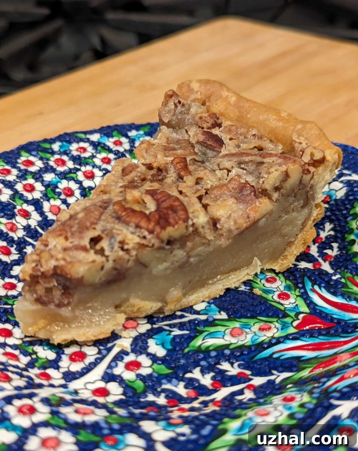 A beautifully baked egg-free pecan pie, golden brown with whole pecans arranged on top, ready to be sliced.