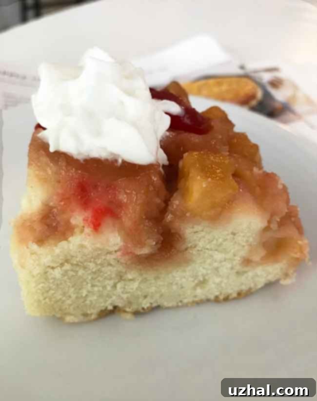 A small slice of homemade pineapple upside down cake for two, showing the moist cake and caramelized fruit topping.