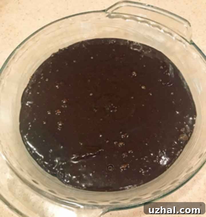 Close-up of brownie crust baking in a pie dish