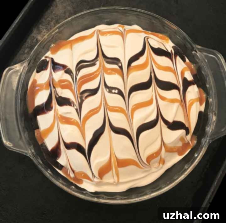 Garnished Mocha Fudge Pie slice with caramel and chocolate syrup
