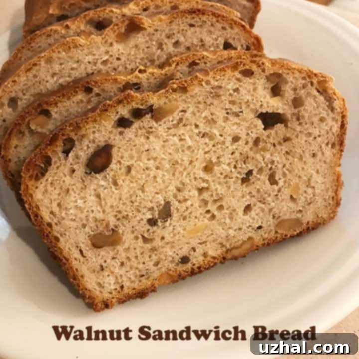 Delicious freshly baked Walnut Sandwich Bread sliced on a cutting board, ready for enjoyment.
