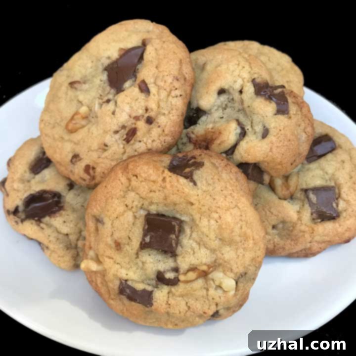 Perfectly baked golden-brown chocolate chip cookies, featuring a slightly puffed texture and melted chocolate chunks