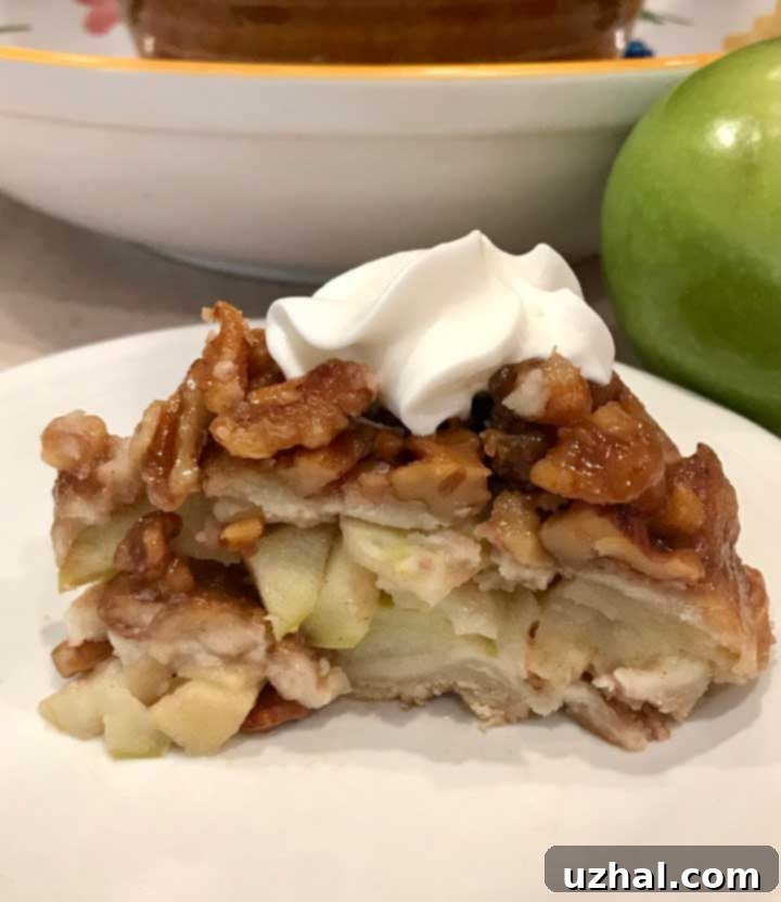 A perfect slice of Upside Down Apple Pie on a plate.