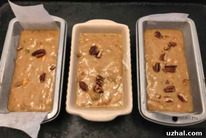 Three mini loaves of persimmon bread, perfectly golden and ready to be shared.