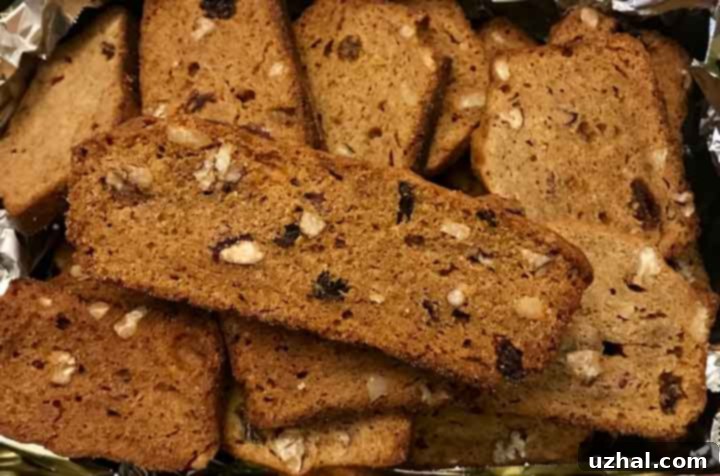 Persimmon biscotti slices, arranged on a baking sheet, golden and crisp.