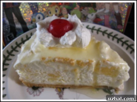 Delightful slice of award-winning frozen pineapple cheesecake with a vibrant glaze, perfect for a no-bake tropical dessert.