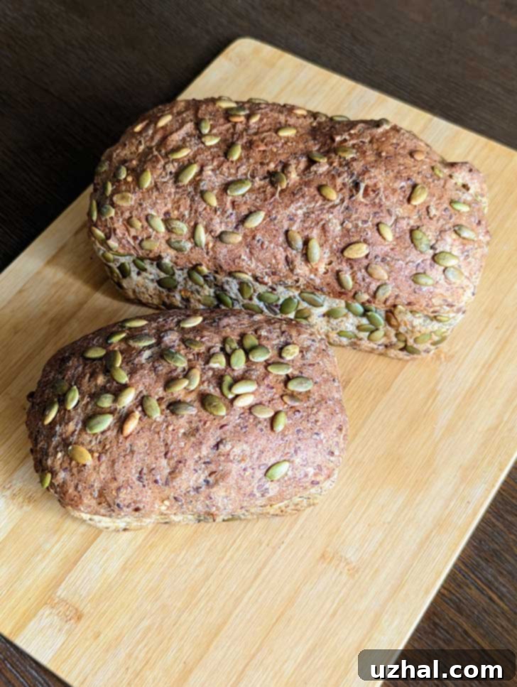 Two perfectly baked loaves of homemade super seed bread, cooling on a wire rack, ready to be sliced and enjoyed.