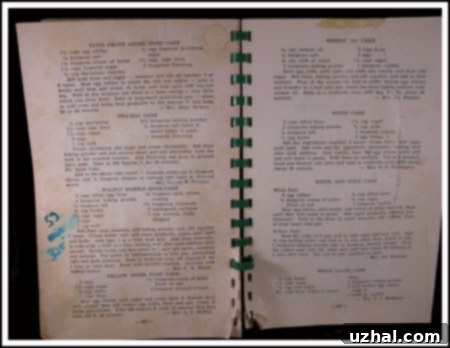 An open vintage Methodist Cookbook showcasing the handwritten recipe for Walnut Marble Spice Cake on its aged pages, evoking a sense of culinary history and tradition.