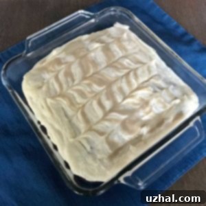 Delicious Tahini Carrot Cake with Tahini Frosting on a cooling rack.