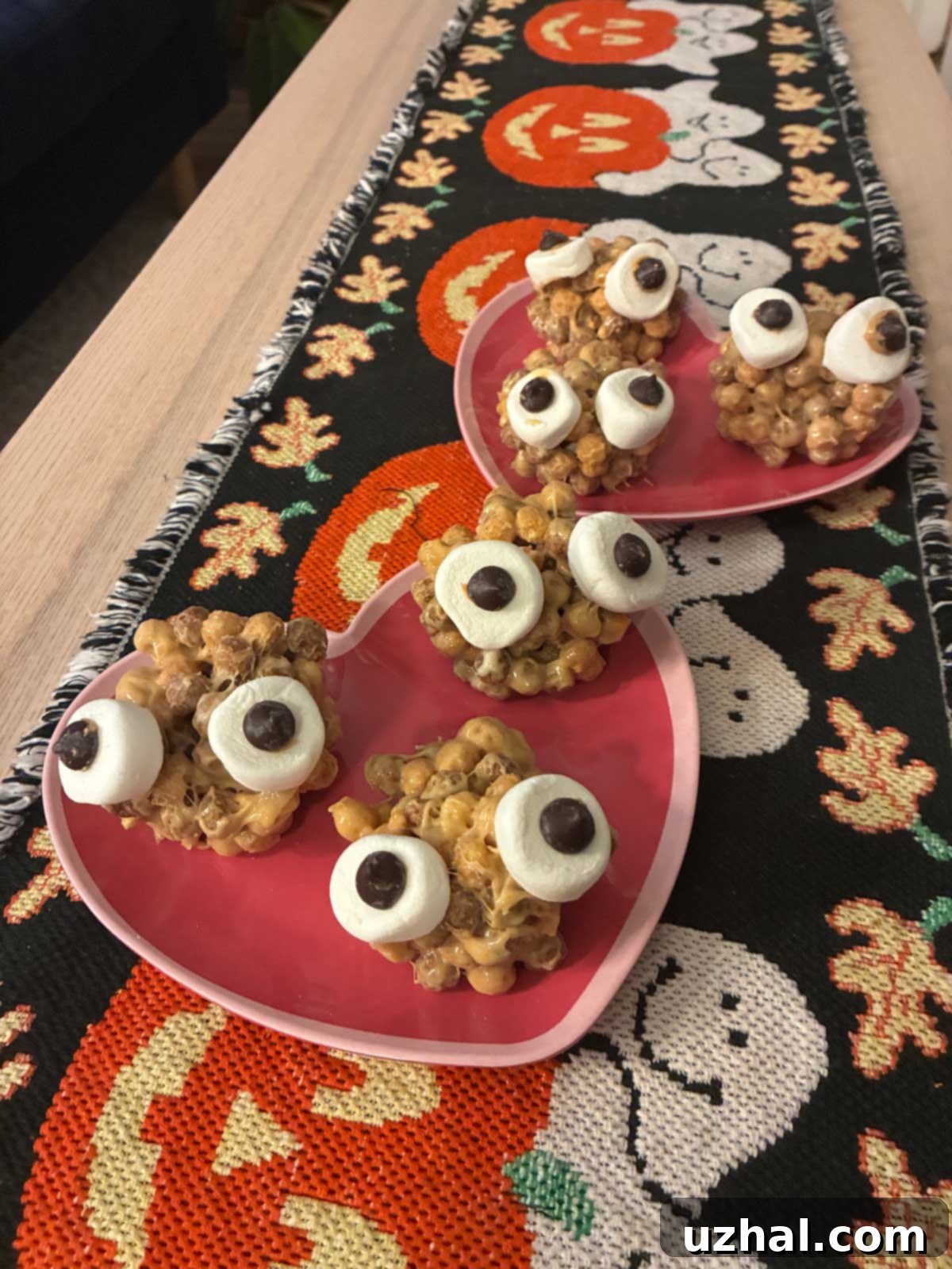 Easy Halloween Swamp Monsters cookies with Reese's Puffs, marshmallows, and chocolate chips on a Halloween-themed platter.