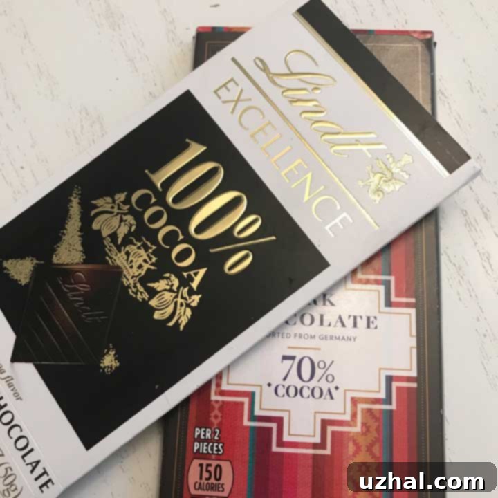 High-quality unsweetened and 70% cocoa dark chocolate bars from brands like Lindt and Aldi on a kitchen counter, essential for rich double chocolate cookies.