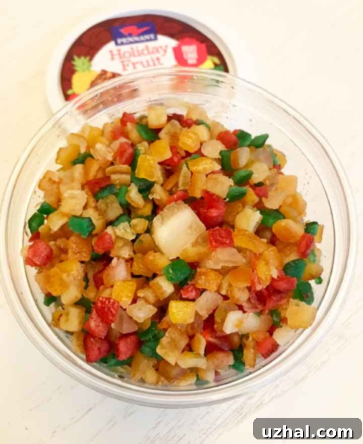 Assortment of vibrant candied fruit, including cherries, pineapple, and citrus peels, ready for use in bourbon cookies.
