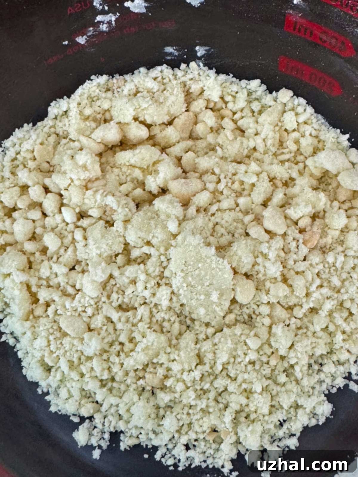 Milk Bar milk crumb mixture, a close-up of the textured, golden brown crumbs.