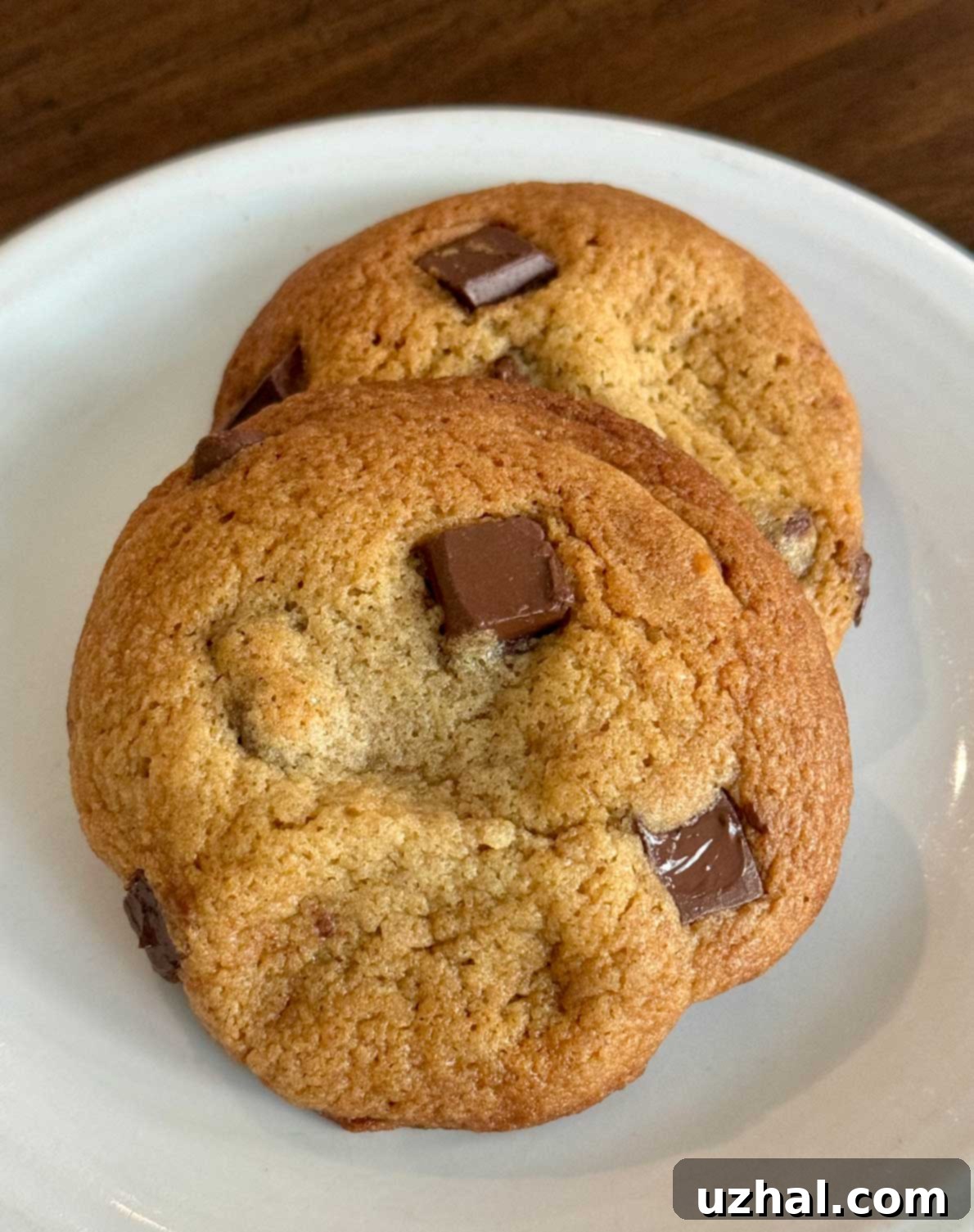Freshly baked chocolate chip cookies made with glucose syrup, showcasing a perfect chewy texture after dough chilling.
