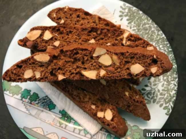 An array of freshly sliced small batch almond biscotti with coconut sugar, cooling on a rack, ready to be double-baked.