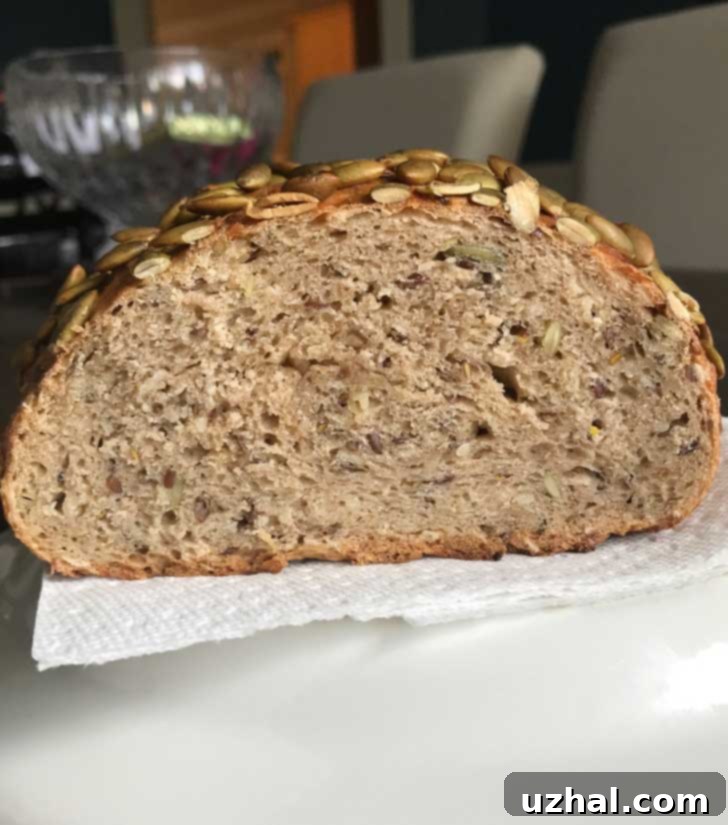 Picture of Martha Stewart's No-Knead Seed Bread sliced, revealing a beautiful crumb structure and an abundance of mixed seeds.