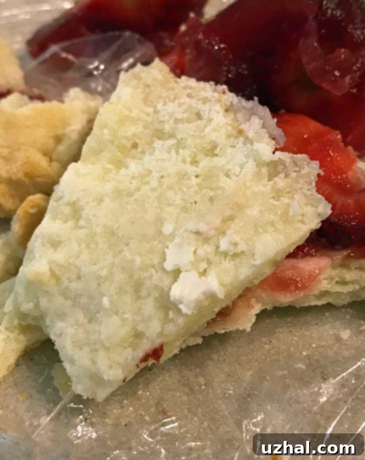 Close-up of a baked gluten-free pie crust showing how flaky it is, with distinct layers visible on the cut edge.