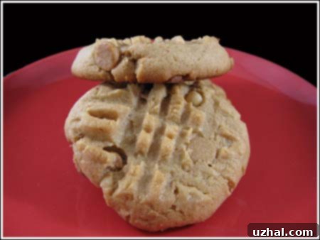 Classic Peanut Butter Criss-Cross Cookies with fork marks on a baking sheet