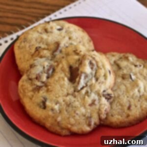 Close-up of freshly baked Toblerone Minnesota Munchers, highlighting the chopped Toblerone pieces, toffee chips, and pecans that give them a unique chewiness and rich flavor.