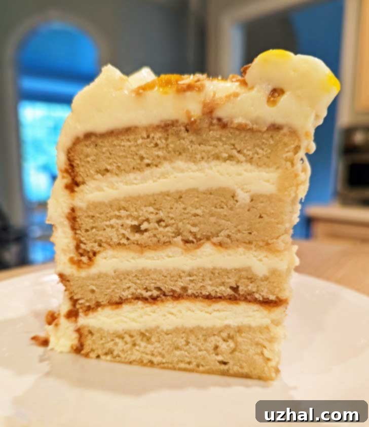 6-Inch Coconut Layer Cake 3 A 6-inch flour layer coconut cake, made with gluten-free flour, sitting on a white plate with a kitchen background.