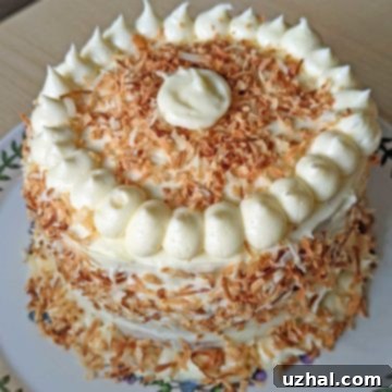 6-Inch Coconut Layer Cake 4 A 6-inch coconut layer cake on a plate, ready to be served.