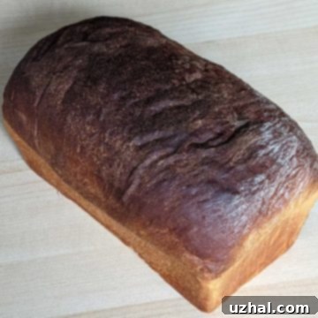 A freshly baked Potato Flour Sandwich Bread loaf, golden brown and inviting.
