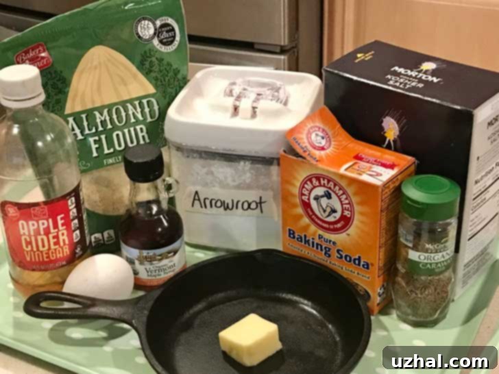 Ingredients lined up for Almond Meal Irish Soda Bread, including almond meal, arrowroot starch, caraway seeds, egg, and maple syrup.