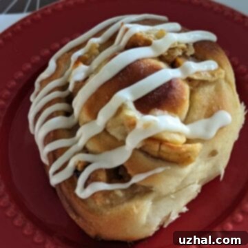 A close-up shot of freshly baked Apple Pie Cinnamon Rolls, ready to be glazed.