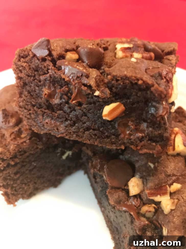 Two types of cake mix brownies, chocolate and yellow, on a white plate, showcasing their varied appearance.