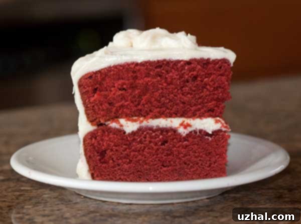 Stunning favorite red velvet cake with vibrant color and cream cheese frosting, easily adaptable to an 8-inch size.