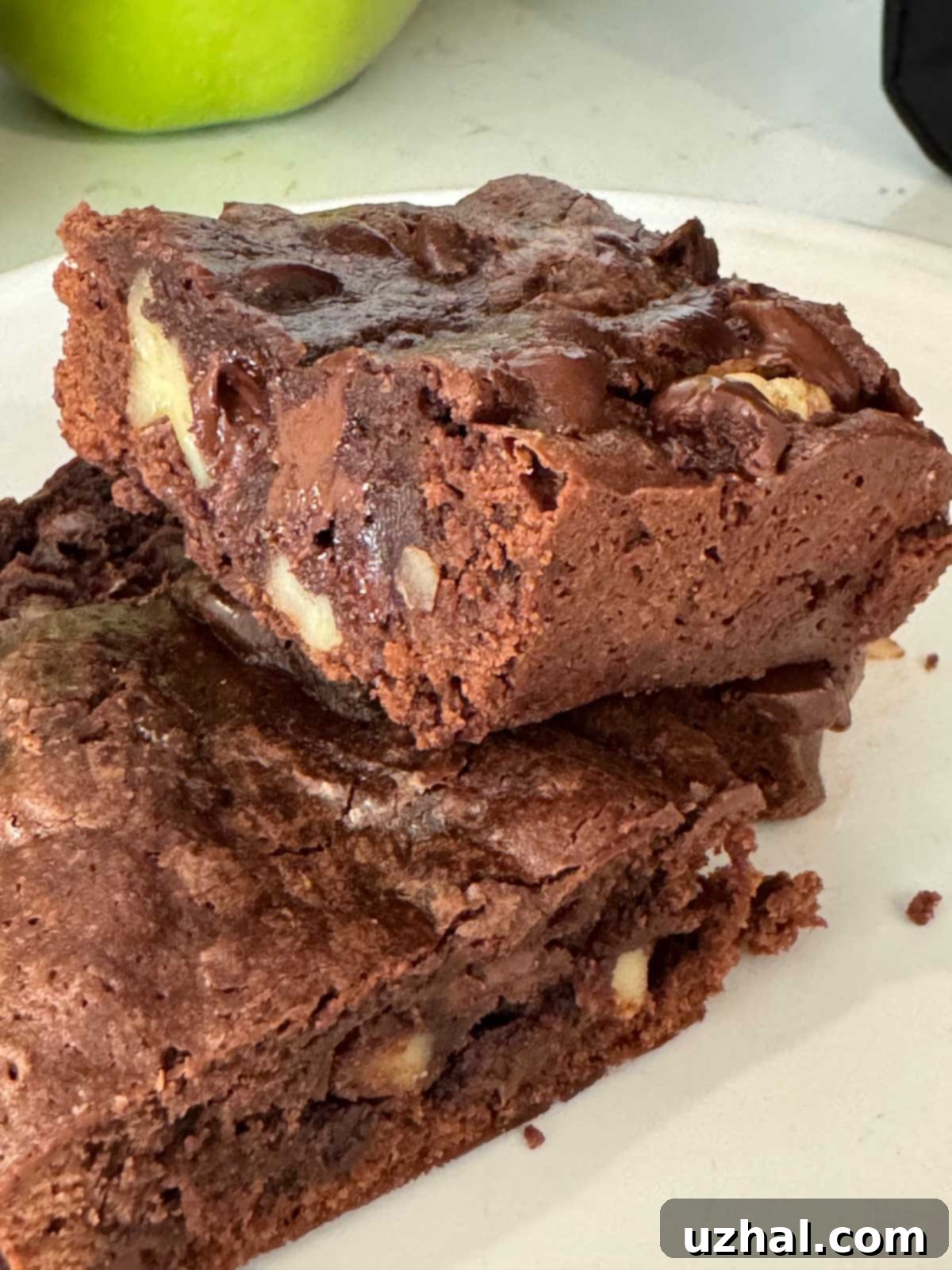Delicious and fudgy Olive Oil Brownies on a cooling rack, showcasing their rich, dark color and slightly crackled top, ready to be cut into squares.