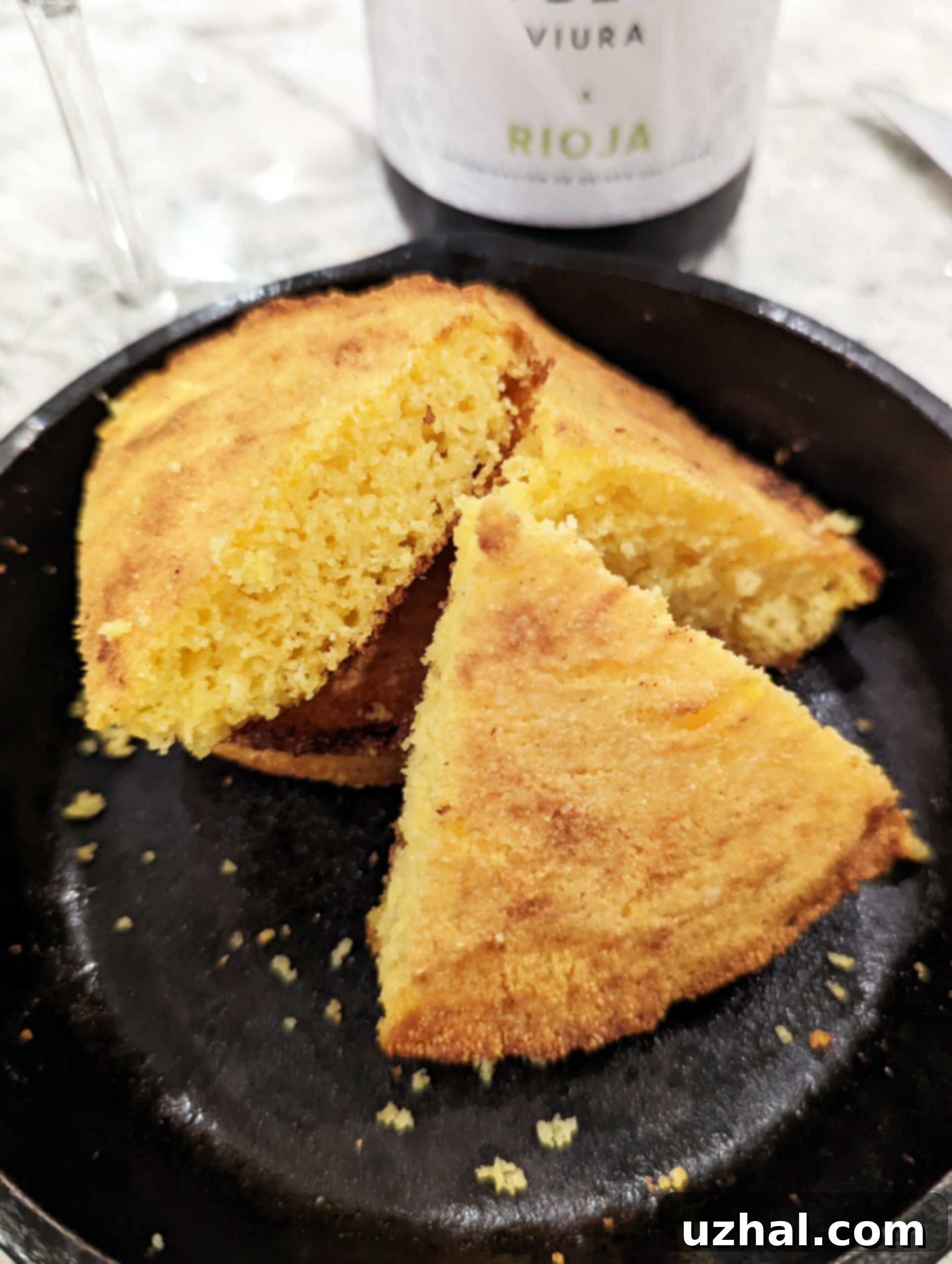 A slice of cornbread with a glass of White Rioja wine.