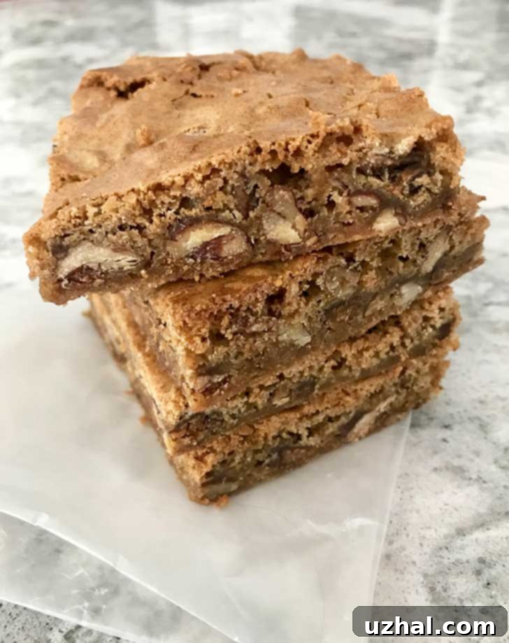 A large tray of freshly baked Gluten-Free Charleston Chewies, cut into uniform squares, suggesting a generous batch ready for sharing.
