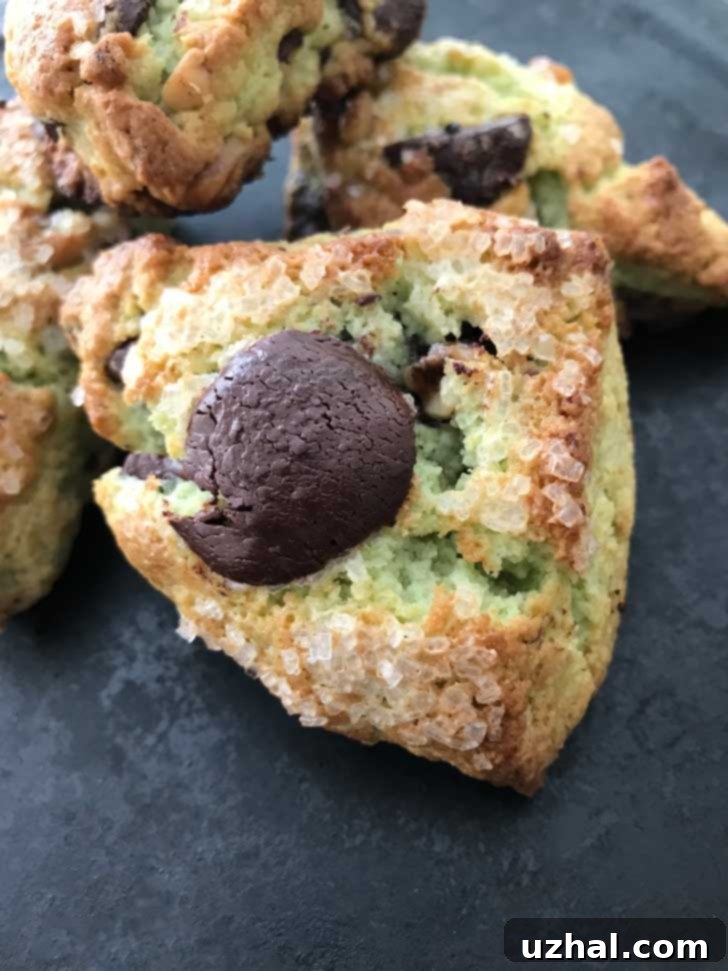 Freshly baked Pistachio Pudding Mix Scones on a cooling rack, showing their golden brown exterior.