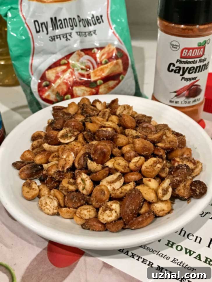 Fiery Peanuts 2 Close-up of freshly made Hot Hot Peanuts seasoned with amchur, garam masala, cayenne, and lime zest, piled generously in a rustic bowl, ready for snacking.