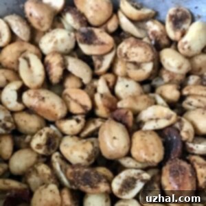 A bowl of Hot Hot Peanuts, perfectly spiced and ready to serve, glistening with a hint of lime.