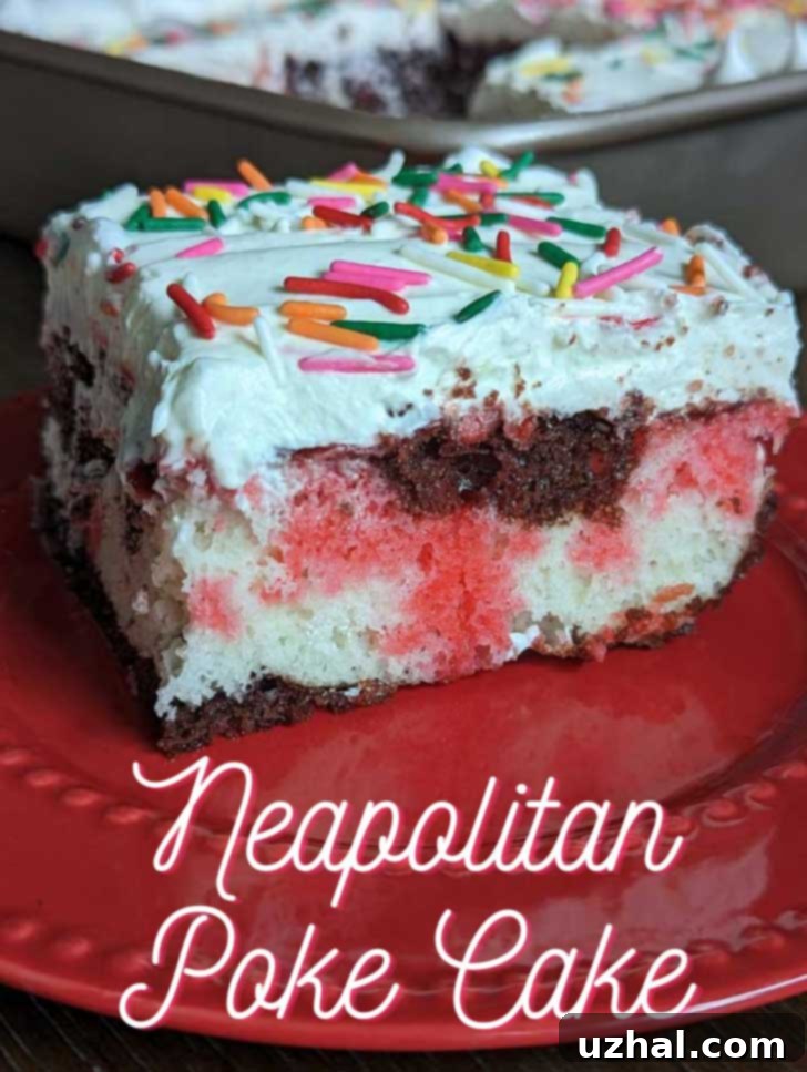 A beautifully layered Neapolitan Poke Cake with chocolate, vanilla, and strawberry flavors, topped with fluffy white frosting.