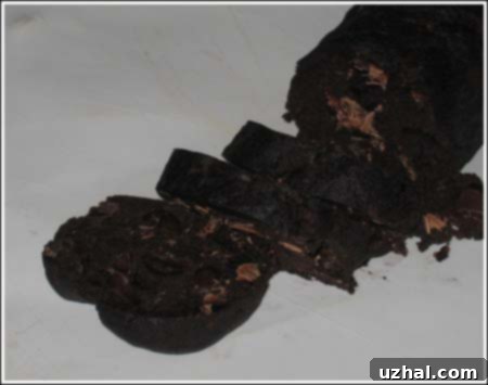 Close-up of a stack of freshly baked Korova Cookies, showing their rich, dark chocolate color and texture.