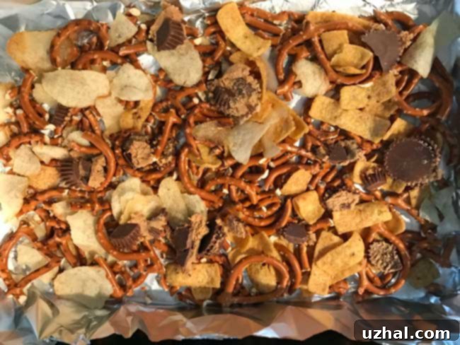 Another view of Frito Candy in a pan before setting, highlighting the various chips and chocolate drizzles.