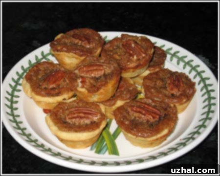Baked Pecan Tassies arranged on a decorative plate, ready to be served