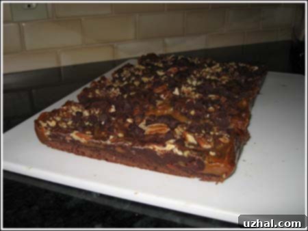 caramel filled brownies being cut into squares