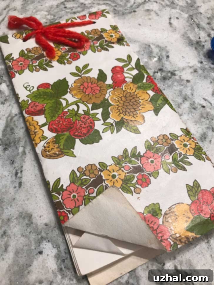 Old Memorial Drive Baptist cookbook with the Four Day Coconut Cake recipe, made from wallpaper samples.