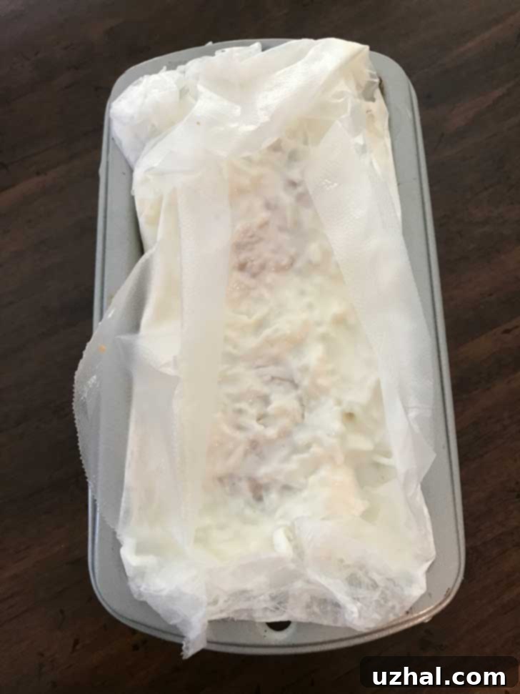 Mini Four Day Coconut Cake made with two leftover white cupcakes in a mini loaf pan.