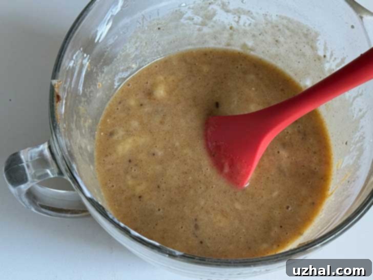 Mixing wet ingredients for Claire Saffitz Almond Butter Banana Bread