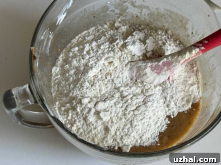 Flour being added to batter for Claire Saffitz Almond Butter Banana Bread
